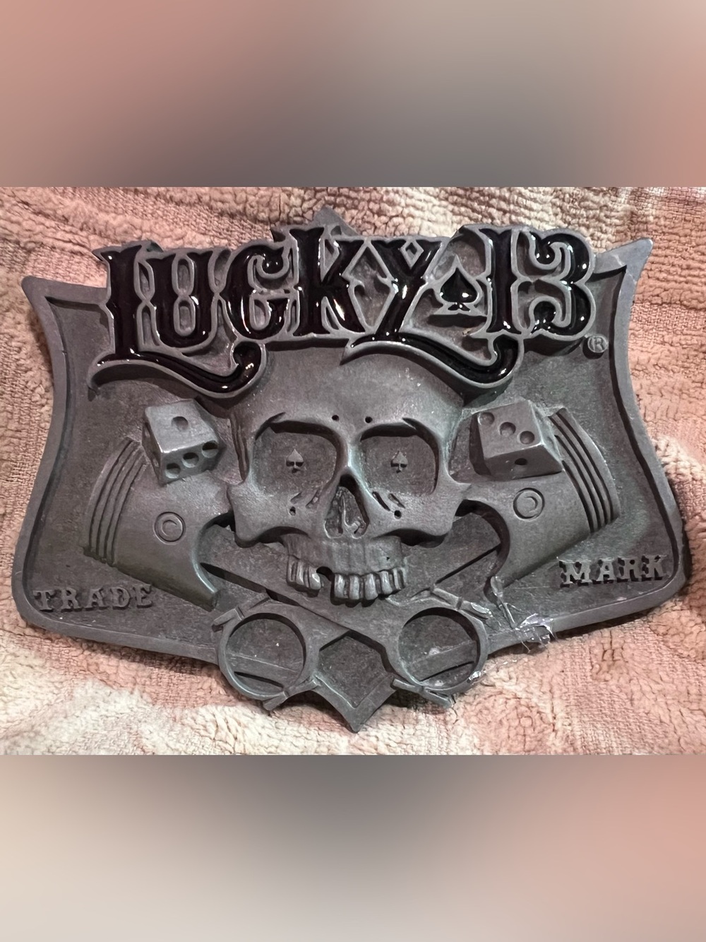 Vintage 2003 Lucky 13 belt buckle featuring skull with crossed pistons